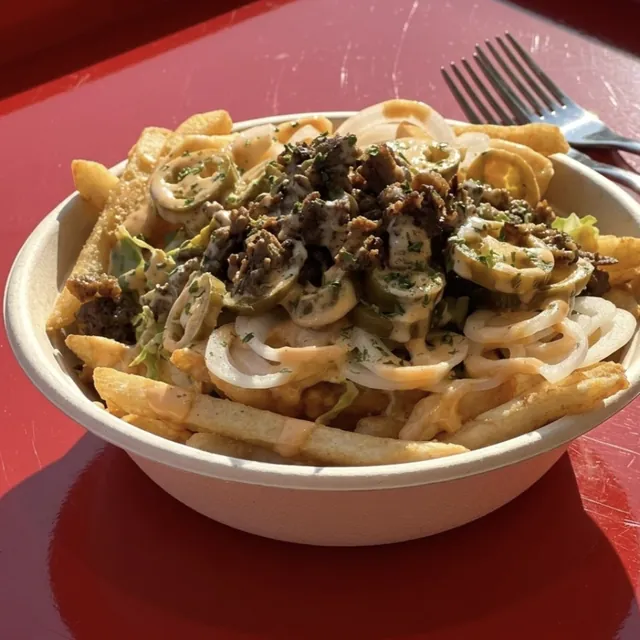Volcano fries loaded with bulgogi, jalapeños and sauce in a paper bowl